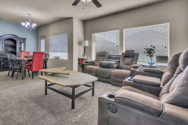 living room featuring ceiling fan with notable chandelier