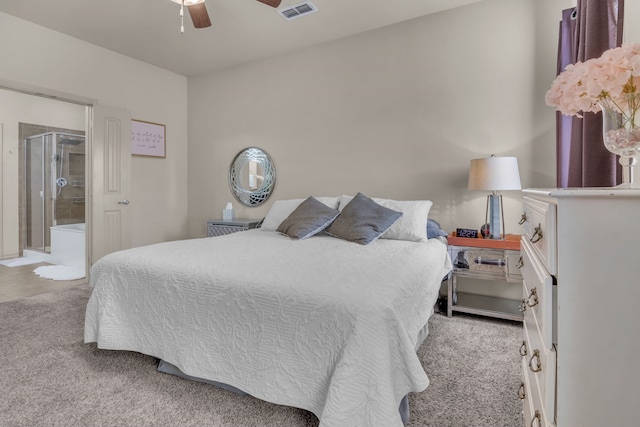 bedroom with light carpet, connected bathroom, and ceiling fan