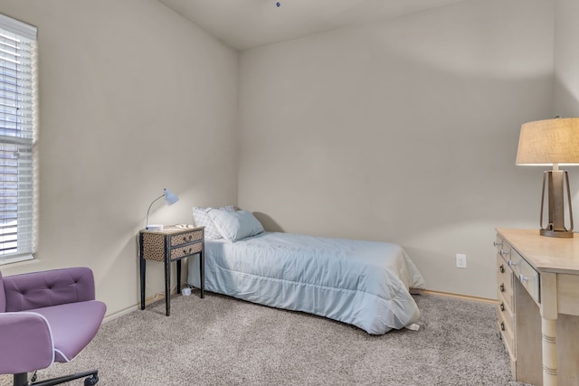 carpeted bedroom featuring multiple windows