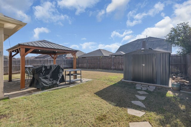 view of yard with a gazebo, a patio area, and a shed