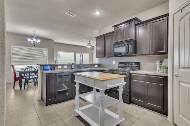 kitchen featuring sink, dark brown cabinets, light tile patterned floors, black appliances, and ceiling fan with notable chandelier