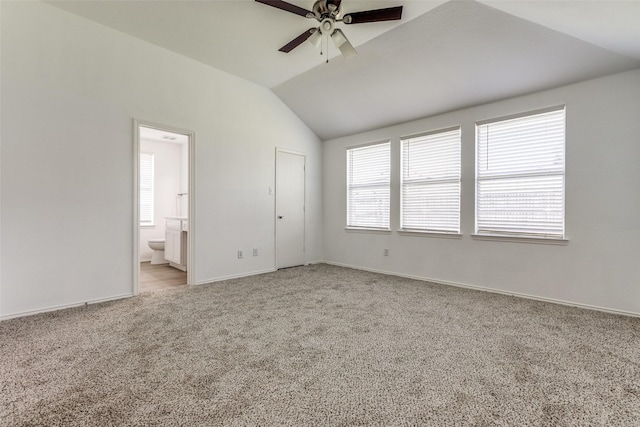 unfurnished bedroom with carpet, lofted ceiling, connected bathroom, a closet, and ceiling fan