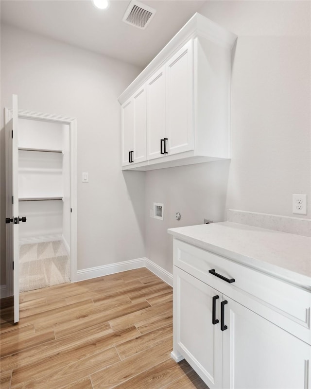 laundry area with hookup for a washing machine and cabinets