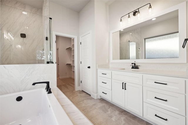 bathroom with vanity and independent shower and bath