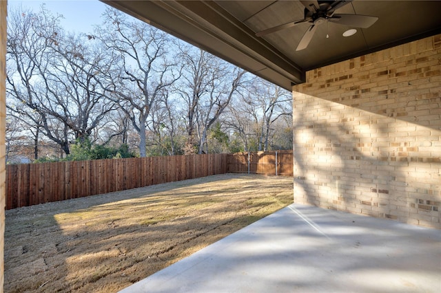 view of yard featuring ceiling fan and a patio