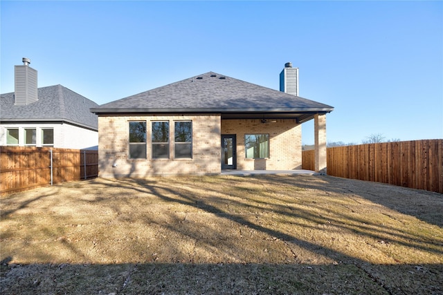 back of property featuring ceiling fan, a patio area, and a yard