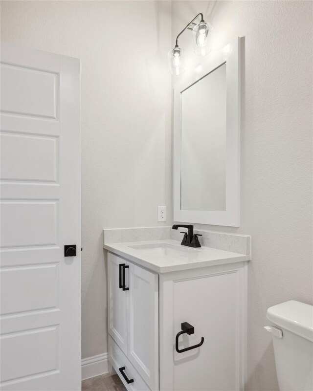 bathroom with vanity and toilet