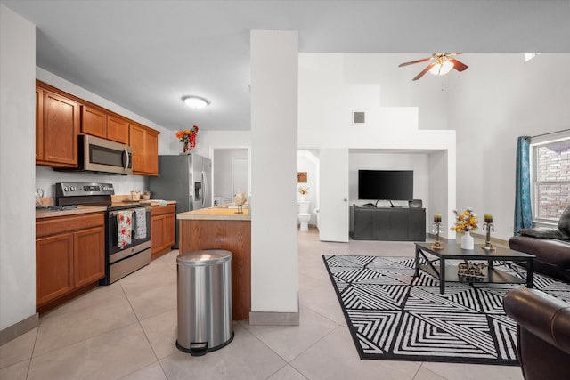 kitchen with ceiling fan, light tile patterned flooring, and appliances with stainless steel finishes