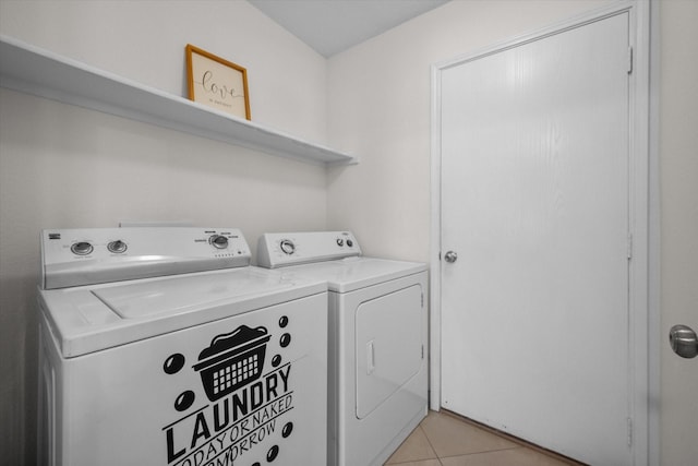 laundry room featuring washer and clothes dryer and light tile patterned floors