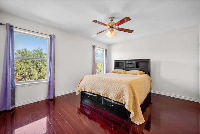 bedroom with ceiling fan and dark wood-type flooring