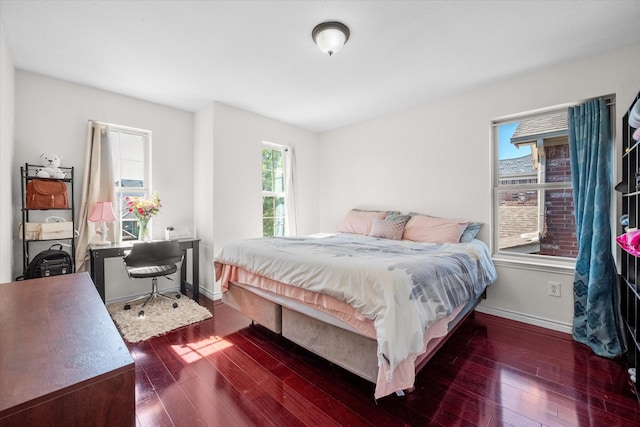 bedroom with dark hardwood / wood-style flooring