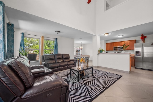 tiled living room featuring a towering ceiling and ceiling fan