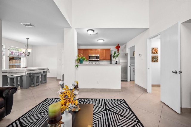 interior space with a chandelier and light tile patterned flooring