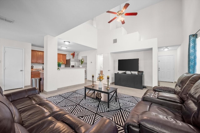 living room featuring ceiling fan, light tile patterned floors, and high vaulted ceiling