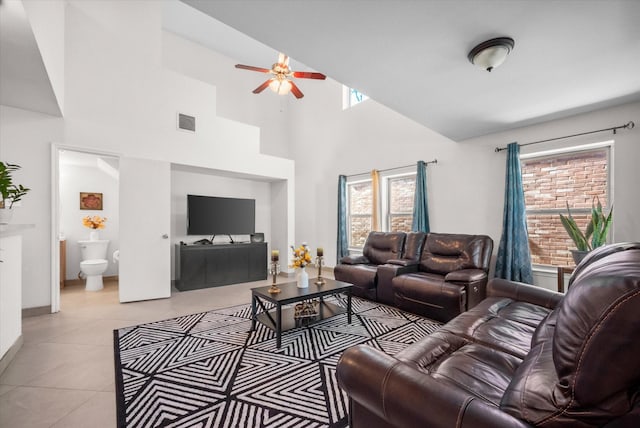 living room featuring ceiling fan, light tile patterned flooring, and high vaulted ceiling