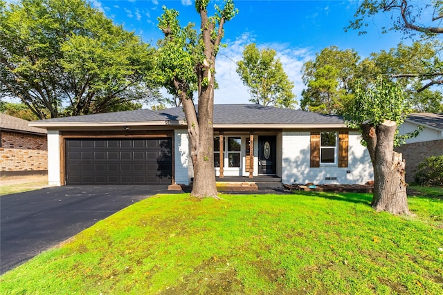 ranch-style house with a garage and a front lawn