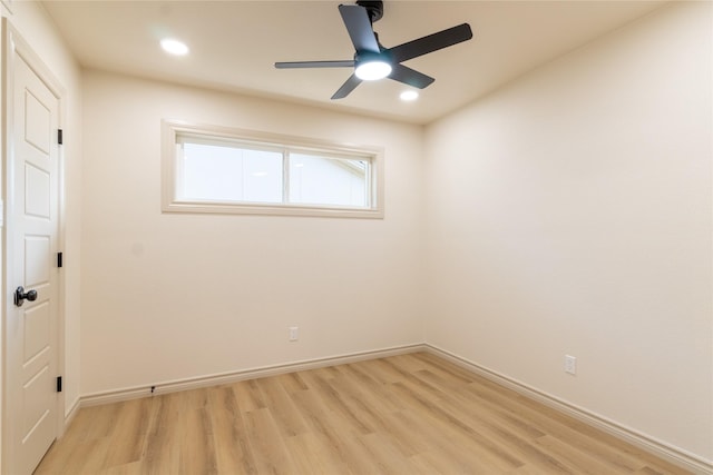 empty room with ceiling fan and light hardwood / wood-style floors