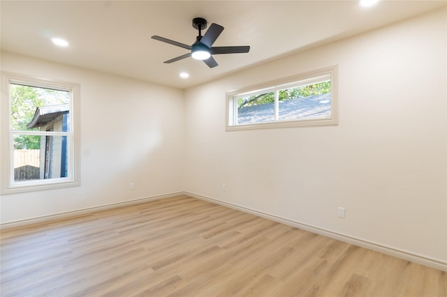 empty room featuring ceiling fan, a healthy amount of sunlight, and light hardwood / wood-style floors