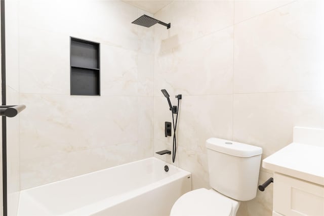 full bathroom with toilet, vanity, tiled shower / bath combo, and tile walls