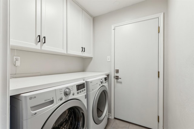 laundry area featuring cabinet space, washer and clothes dryer, and light tile patterned floors