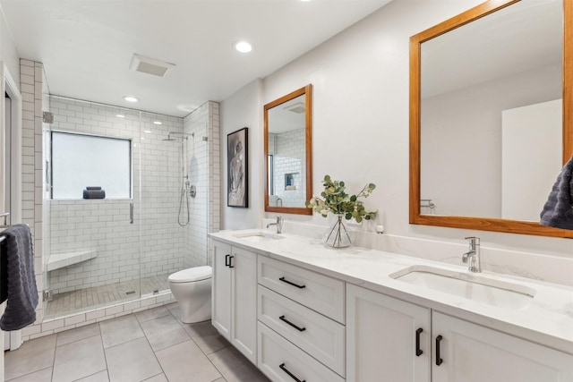 bathroom featuring vanity, tile patterned floors, toilet, and walk in shower