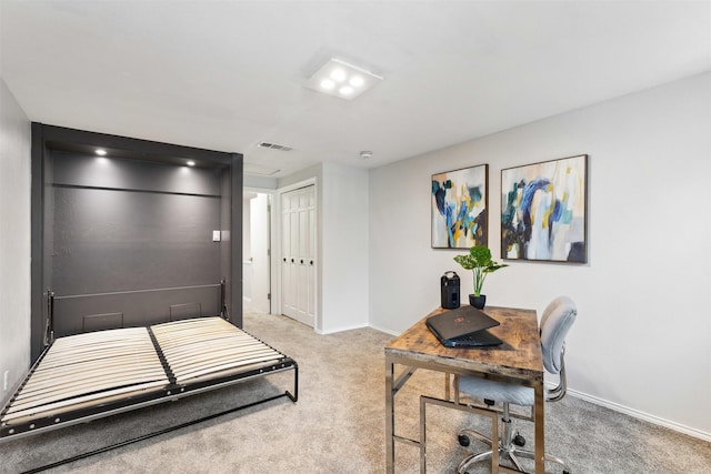 bedroom with baseboards, a closet, visible vents, and light colored carpet