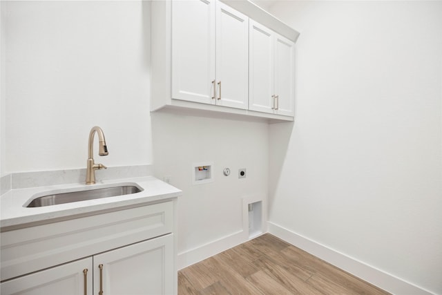 washroom with cabinets, washer hookup, electric dryer hookup, sink, and light hardwood / wood-style flooring