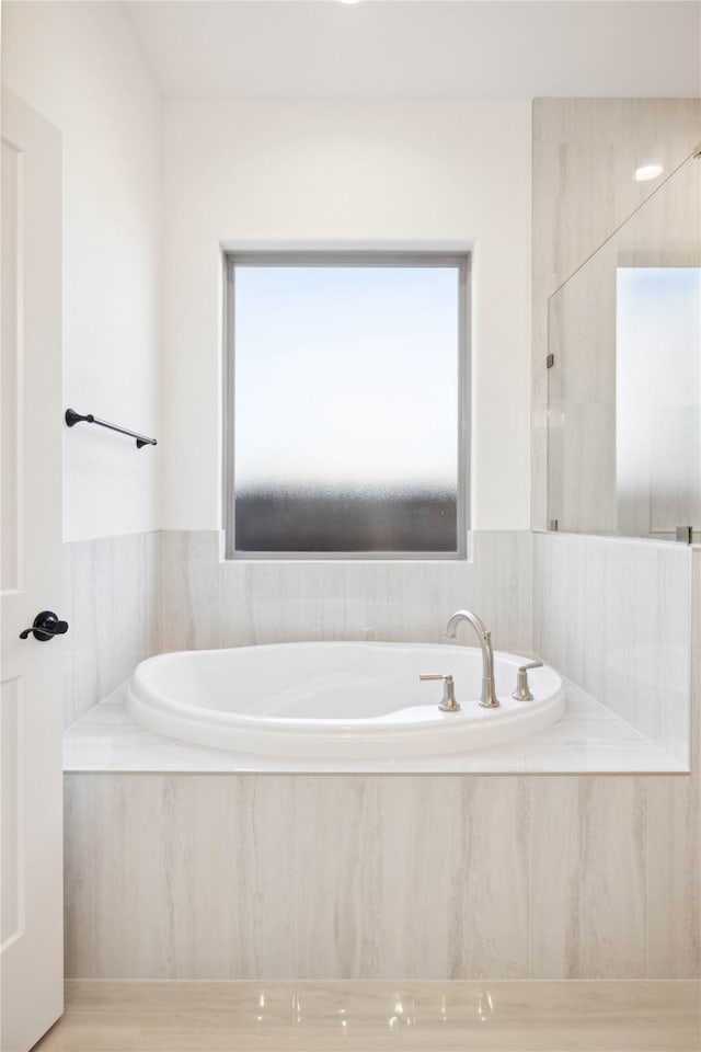 bathroom featuring tiled bath