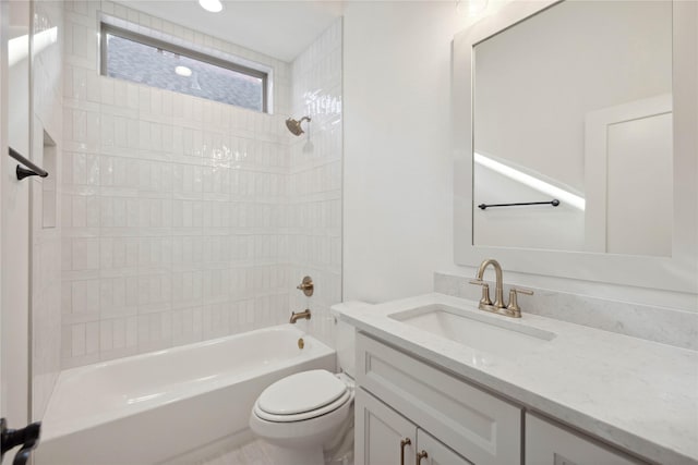 full bathroom with vanity, toilet, and tiled shower / bath