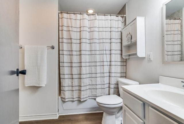 full bathroom featuring shower / bath combination with curtain, vanity, toilet, and hardwood / wood-style floors