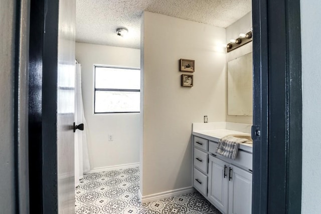 bathroom with vanity and a textured ceiling