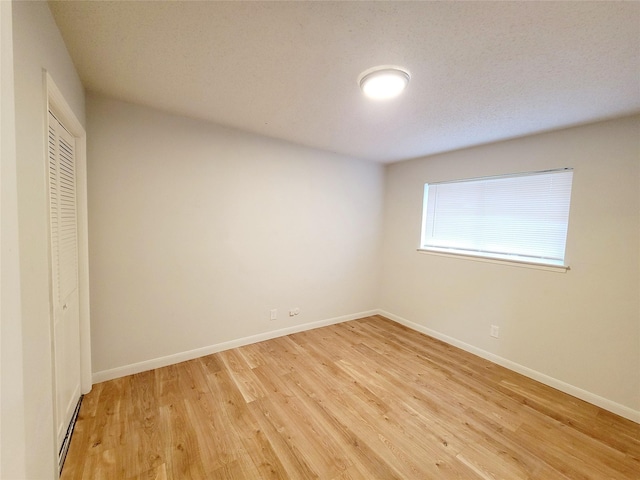 unfurnished bedroom featuring light hardwood / wood-style floors and a closet