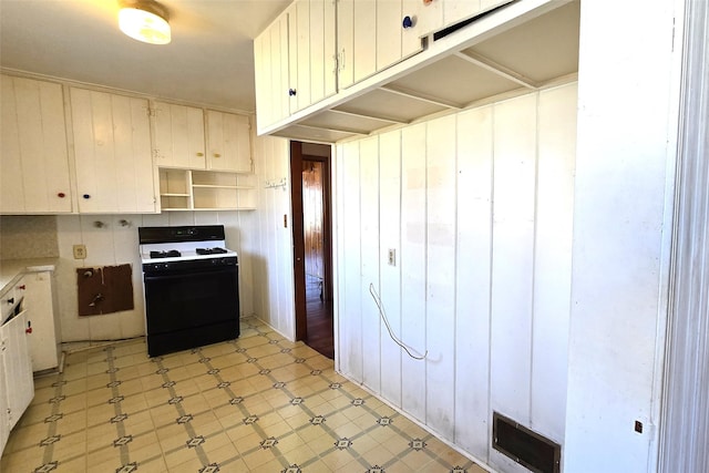 kitchen featuring white cabinets and black gas stove