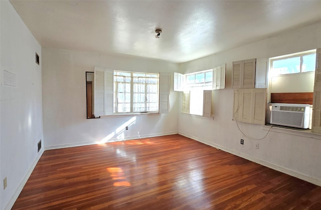 unfurnished room featuring cooling unit and dark hardwood / wood-style flooring