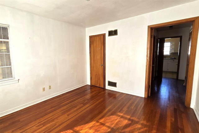 spare room with dark hardwood / wood-style flooring