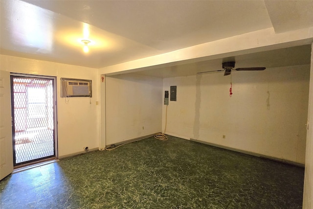 unfurnished room with a wall unit AC, electric panel, and ceiling fan