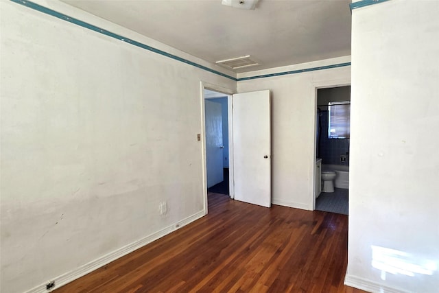 empty room with dark hardwood / wood-style flooring