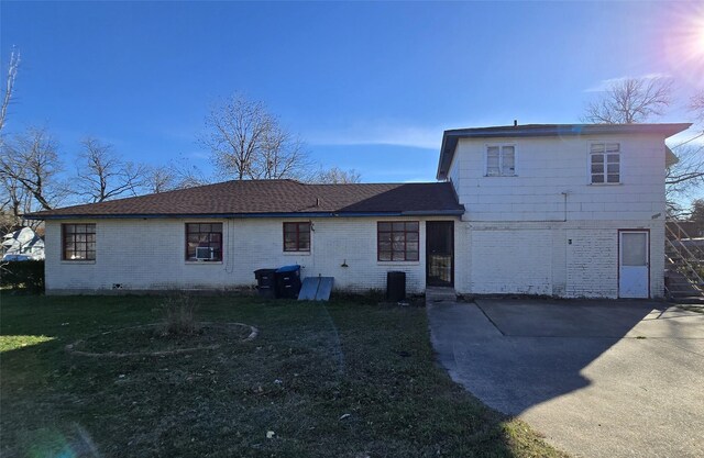 rear view of property with a patio and a lawn