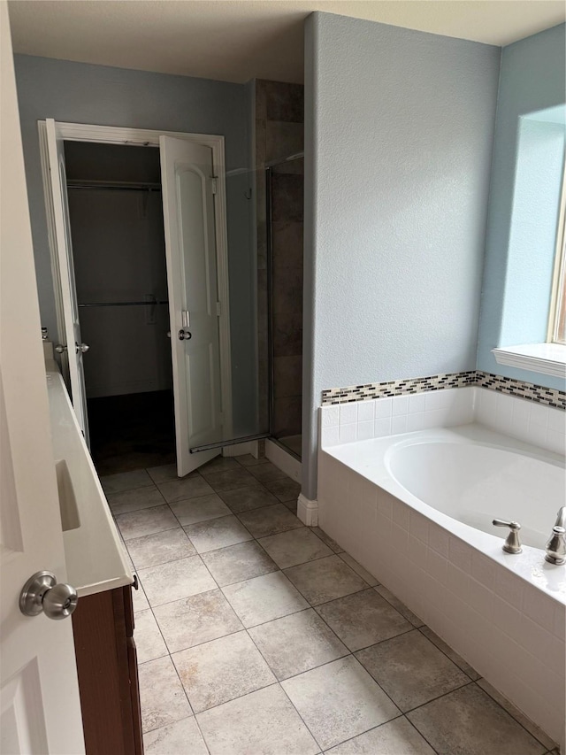 bathroom with tile patterned flooring and plus walk in shower