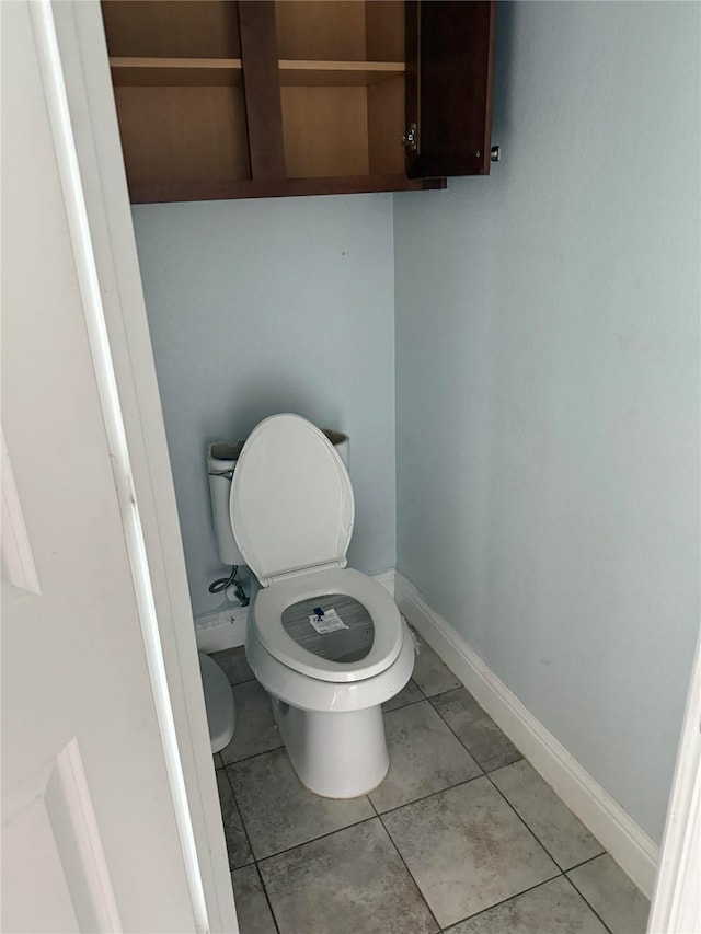 bathroom with tile patterned floors and toilet