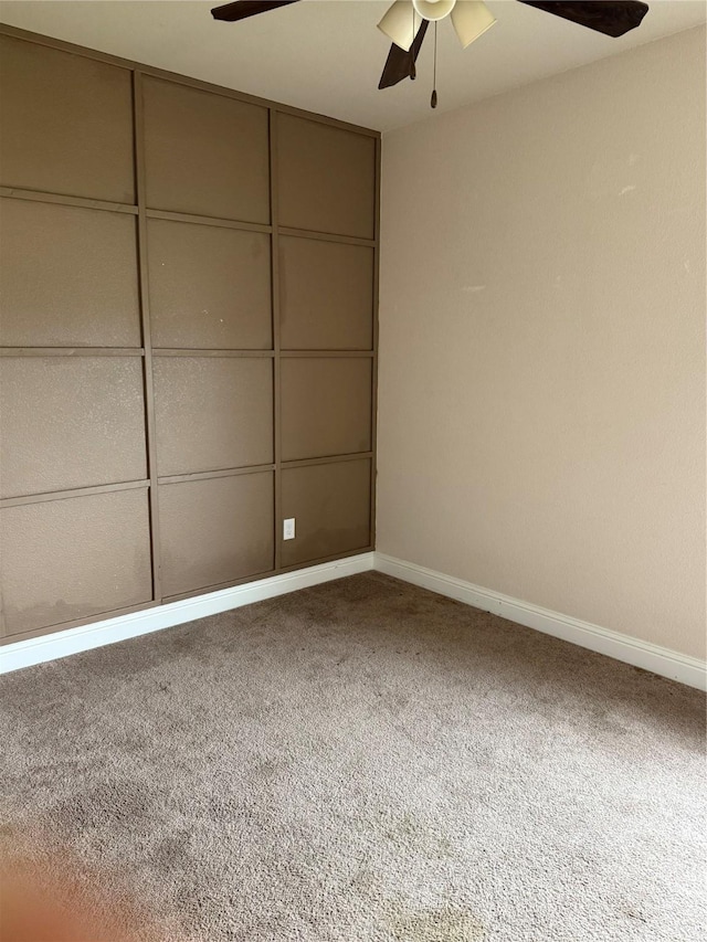 spare room with carpet flooring and ceiling fan