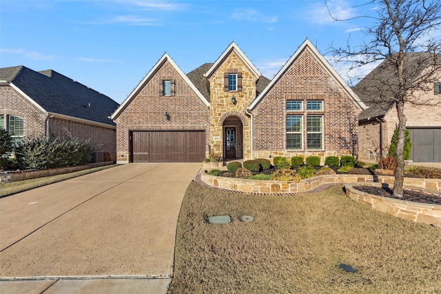 view of front of property featuring a front lawn and a garage