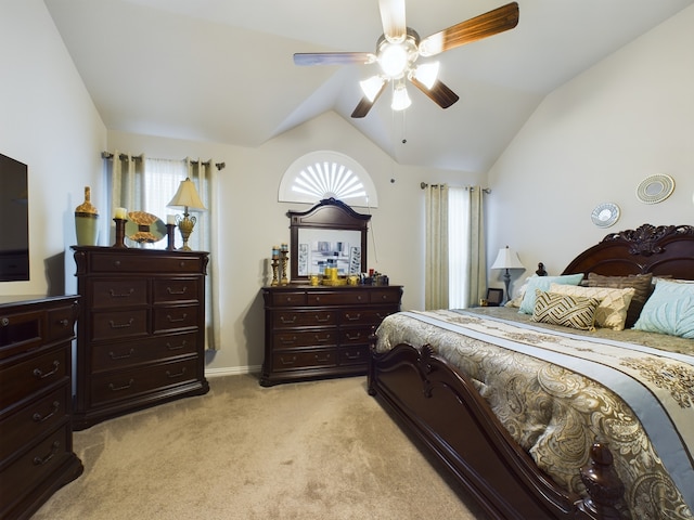 carpeted bedroom with ceiling fan and lofted ceiling