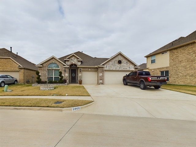 view of front of home featuring a garage and a front yard