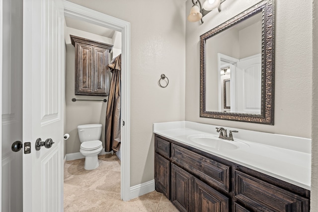 bathroom featuring tile patterned floors, vanity, and toilet