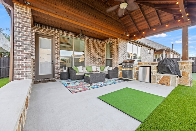 view of patio with a grill, ceiling fan, exterior kitchen, and an outdoor hangout area