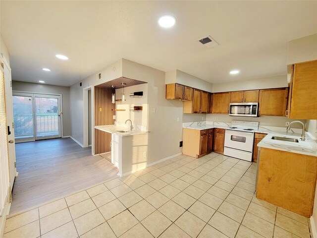 kitchen with sink, light wood-type flooring, and white electric stove