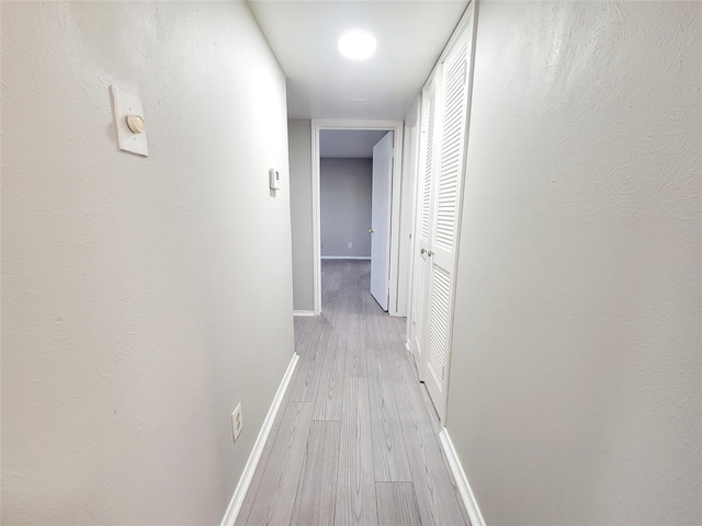 corridor with light hardwood / wood-style floors