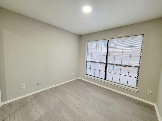 unfurnished room with light wood-type flooring