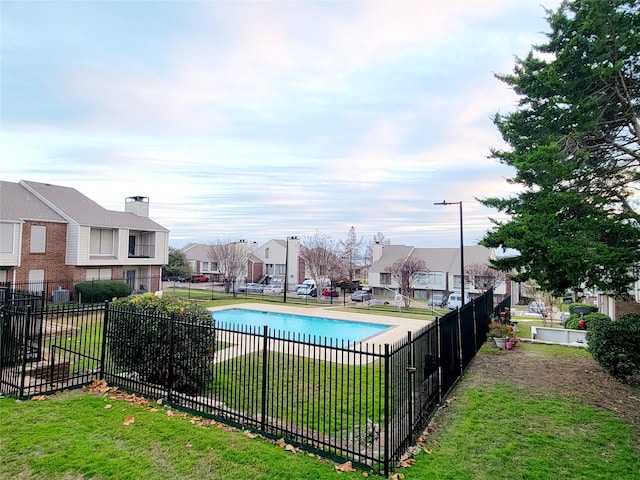 view of pool featuring a yard